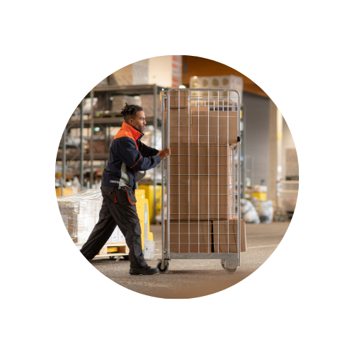 A man who is pusching a roller cart with packages 